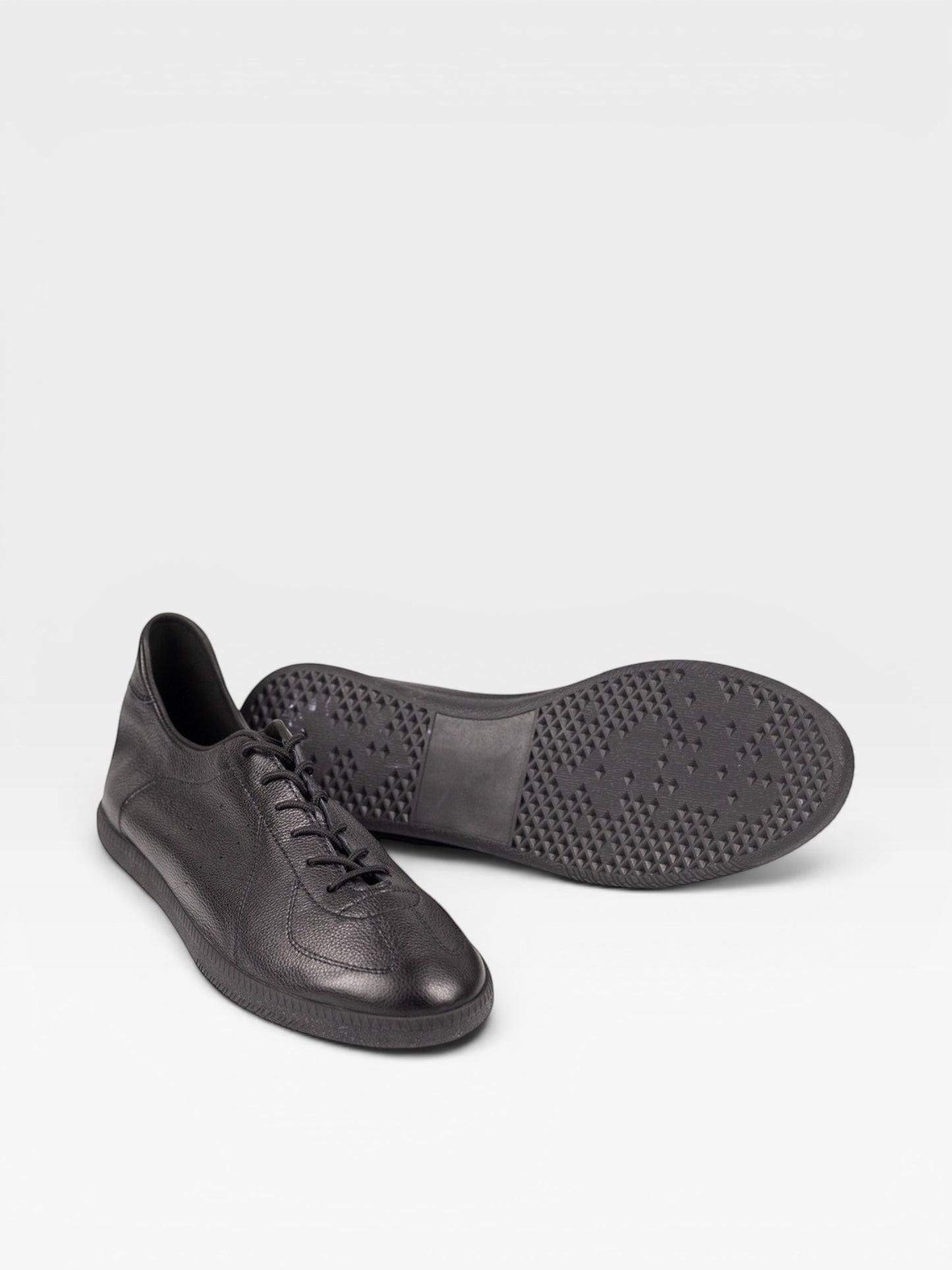 Yeossal black leather unlined GAT sneakers with lace-up closure and textured rubber sole.