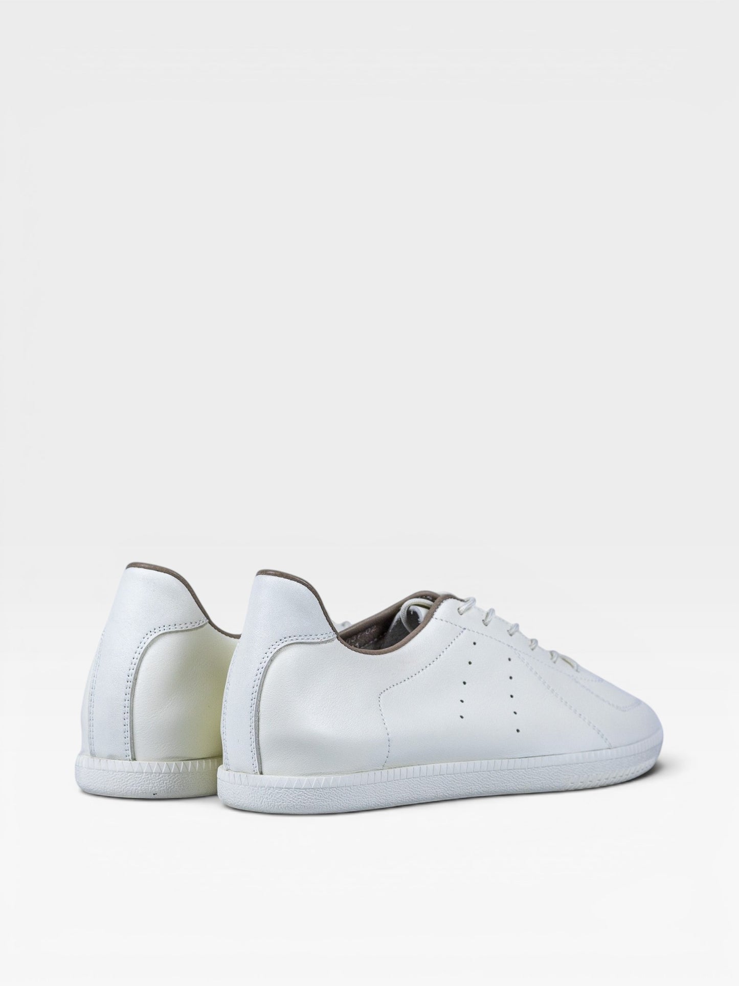 Yeossal white leather unlined GAT sneakers with perforated details and rubber soles.