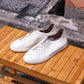 Yeossal white leather unlined GAT sneakers featuring perforated details on the side.